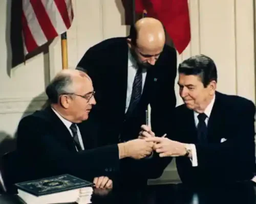 Gorbachev and Ronald Reagan exchange pens as they sign the Intermediate-range Nuclear Forces (INF) treaty, with Pavel Palazhchenko, centre, interpreting, 1987. Photograph: Bob Daugherty/AP