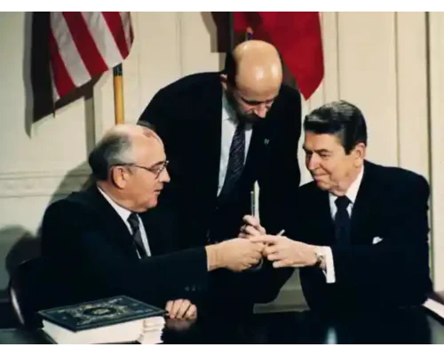 Gorbachev and Ronald Reagan exchange pens as they sign the Intermediate-range Nuclear Forces (INF) treaty, with Pavel Palazhchenko, centre, interpreting, 1987. Photograph: Bob Daugherty/AP