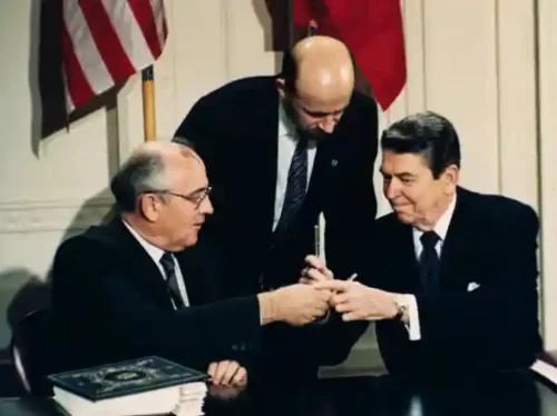 Gorbachev and Ronald Reagan exchange pens as they sign the Intermediate-range Nuclear Forces (INF) treaty, with Pavel Palazhchenko, centre, interpreting, 1987. Photograph: Bob Daugherty/AP